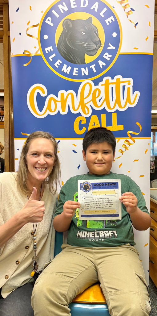 student and staff member smiling