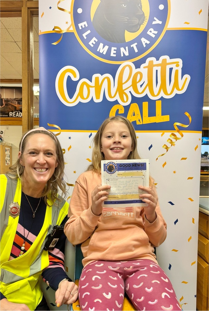 student and staff member smiling