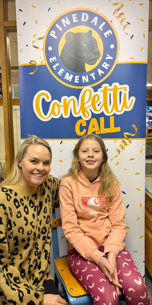 student and staff member smiling