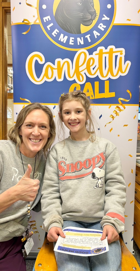 student and staff member smiling