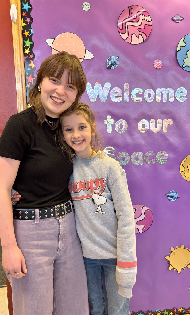 student and staff member smiling