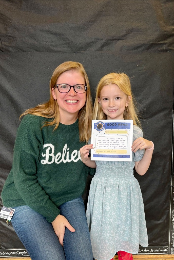 student and staff member smiling