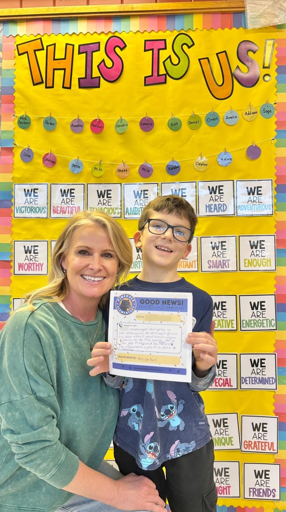 student and staff member smiling