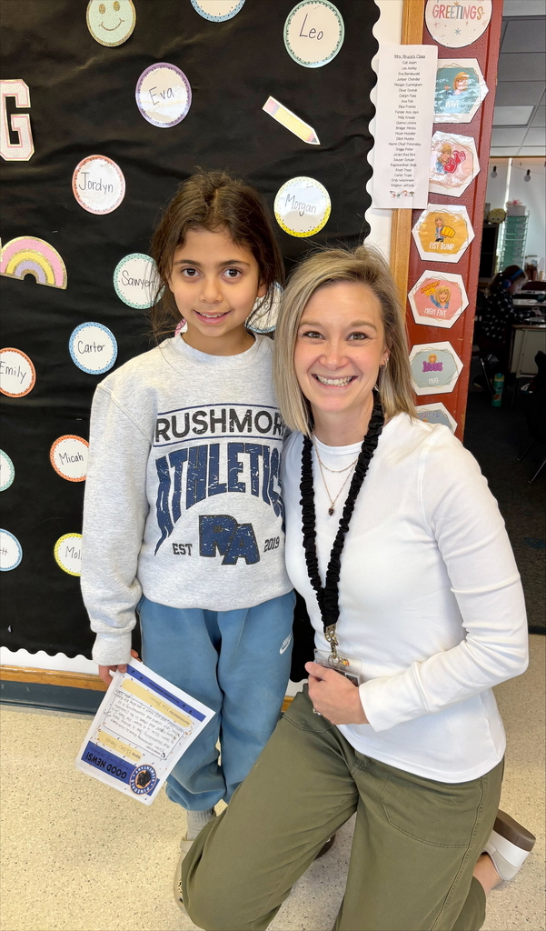student and staff member smiling