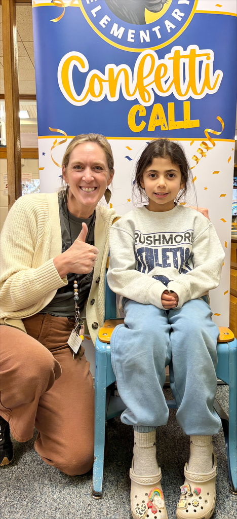 student and staff member smiling