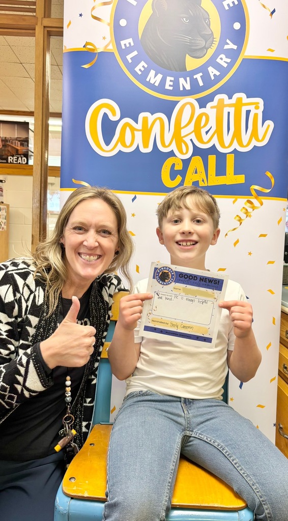 student and staff member smiling