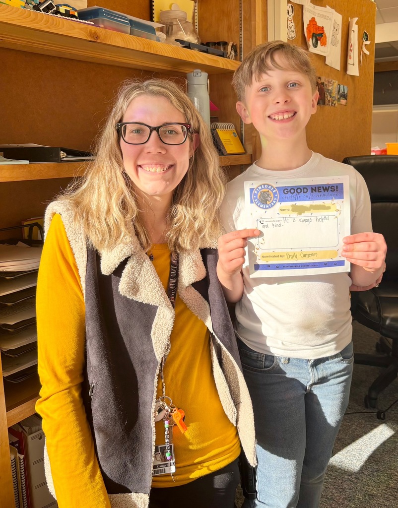 student and staff member smiling