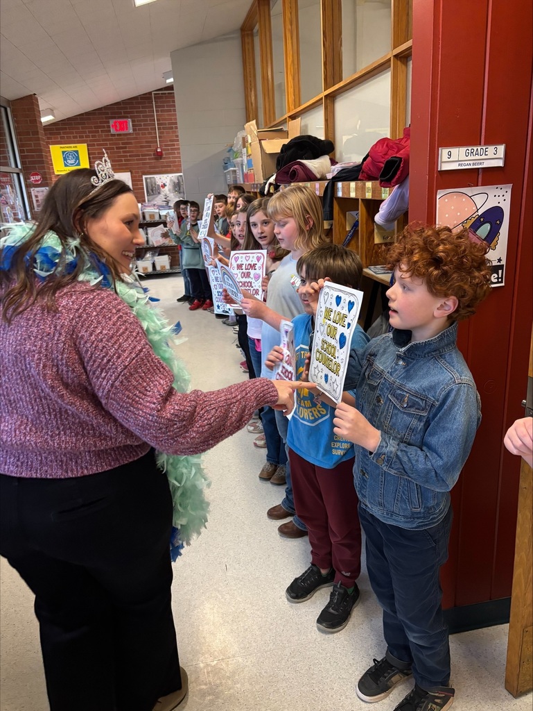 staff in hallway students celebrating