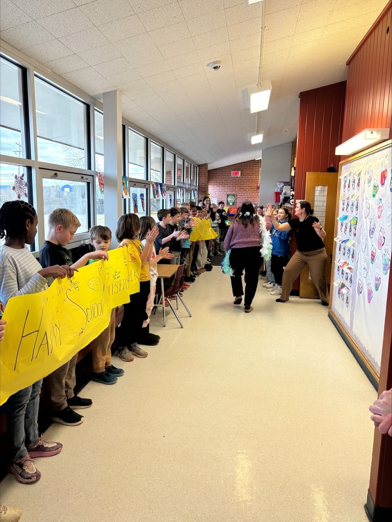 staff in hallway students celebrating