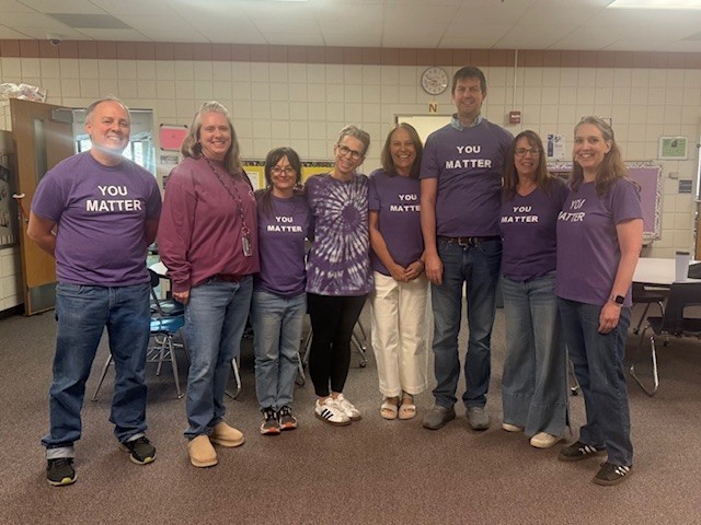 Photo of staff in purple