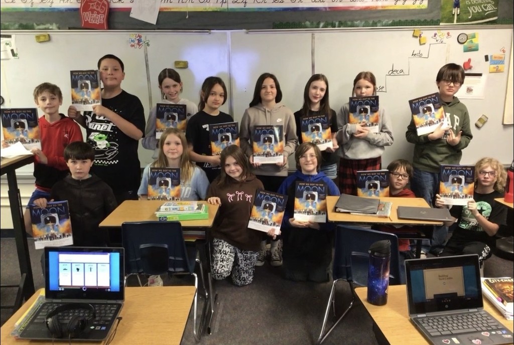 Students with their copy of "How We Got to the Moon"