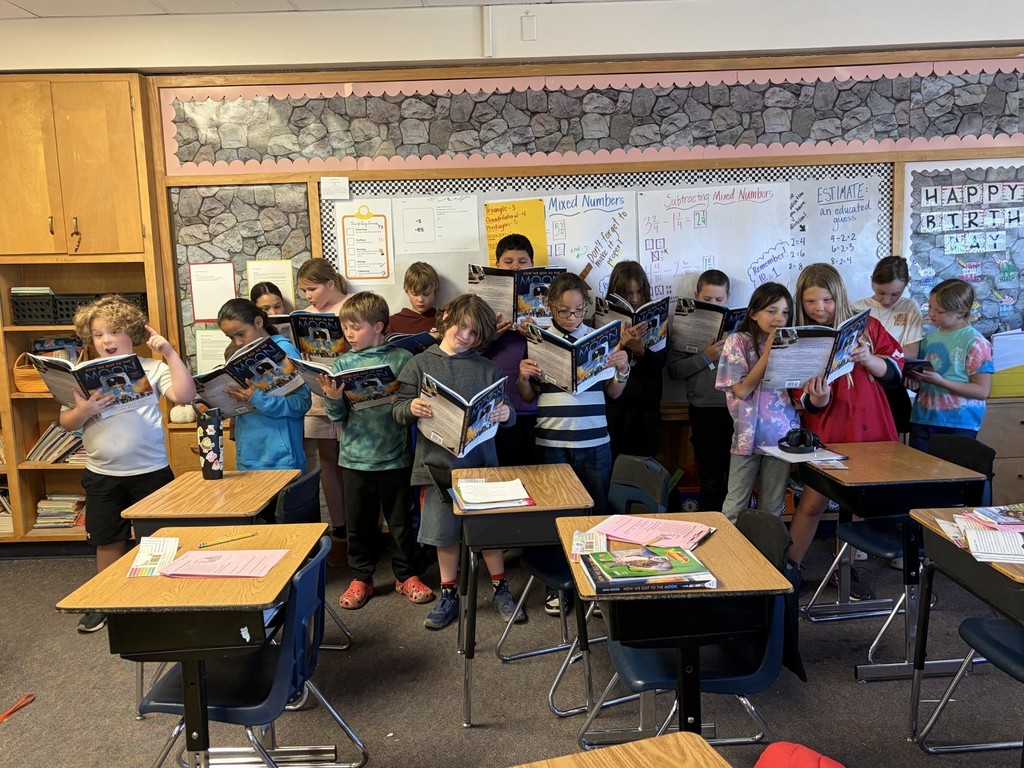 Students with their copy of "How We Got to the Moon"