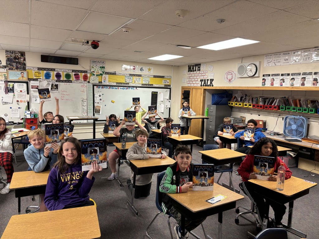 Students with their copy of "How We Got to the Moon"