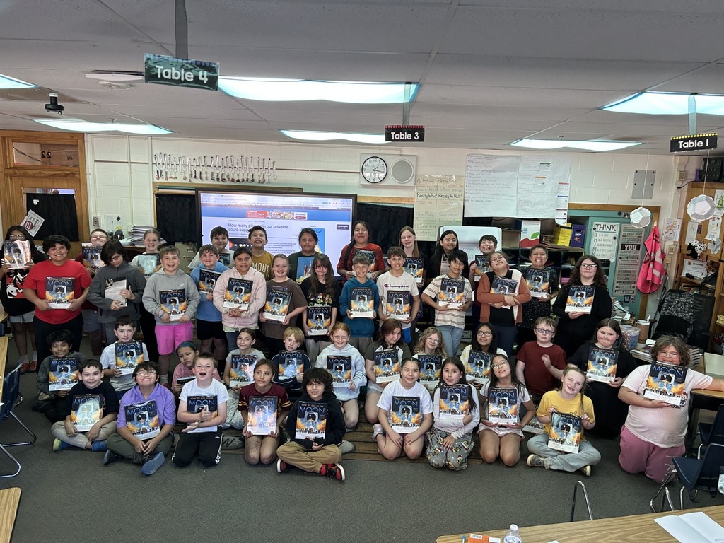 Students with their copy of "How We Got to the Moon"