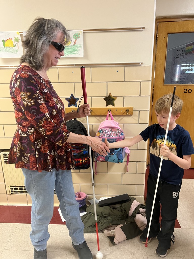 student shaking hands with guest