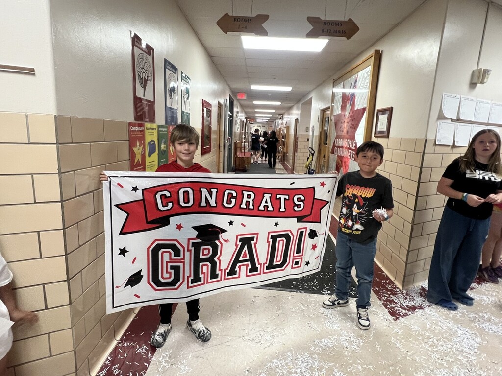 Students holding congratulations sign