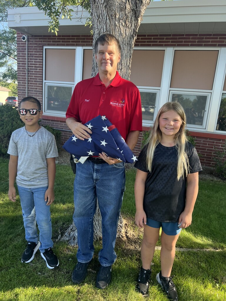 Staff and Students with flag
