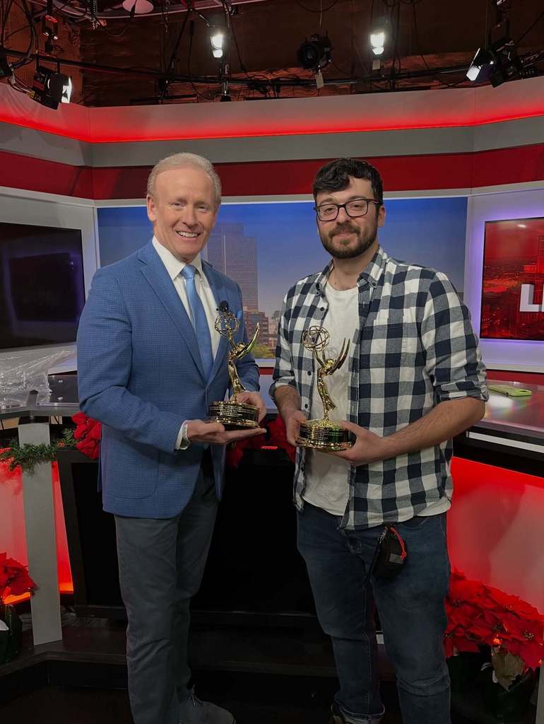 Alumni Zach Clouse poses with Emmy with News Channel 13 anchor Mark Mulholland