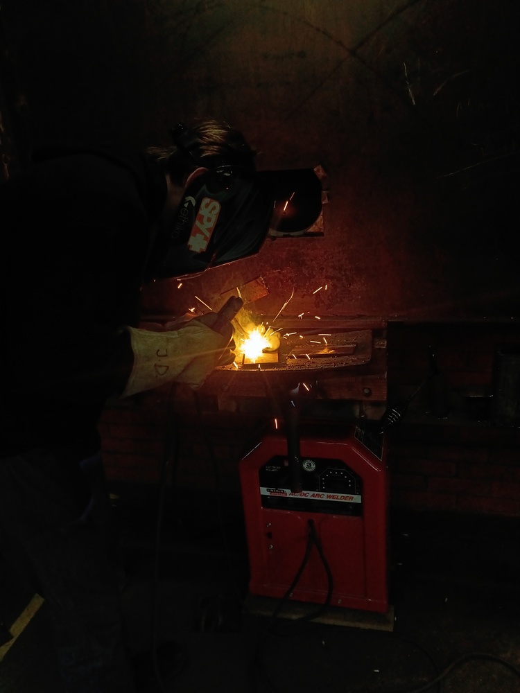 A student in the process of Arc welding