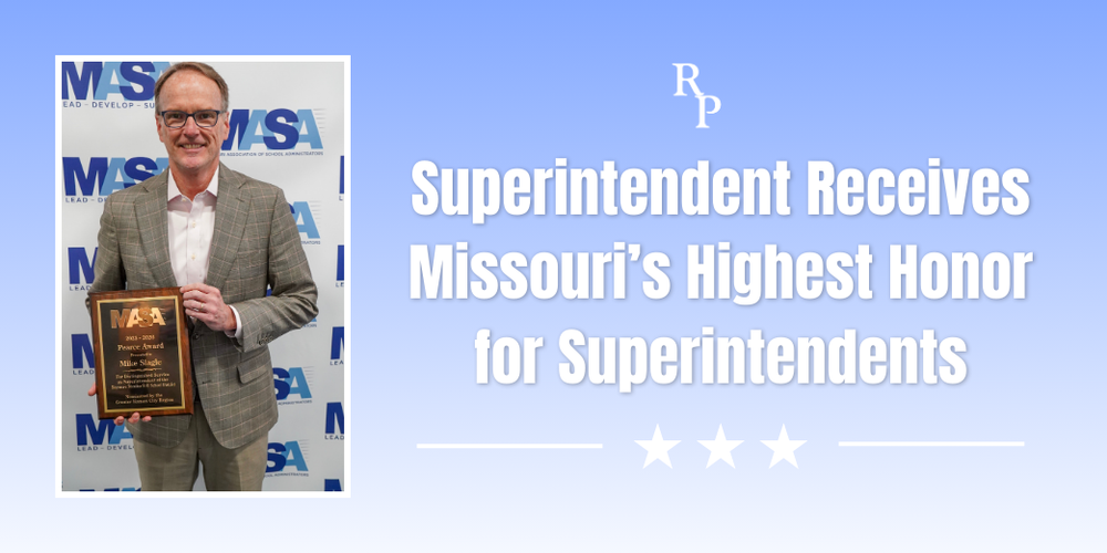 A man smiling with a plaque