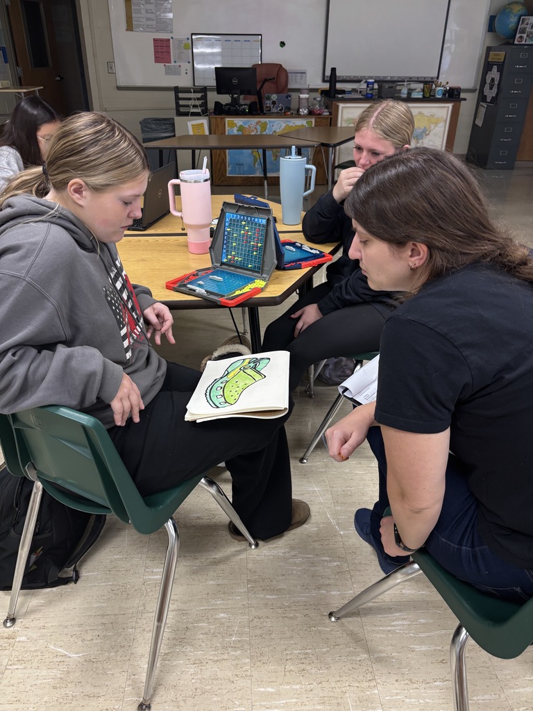 Student and teacher conferencing about learning.