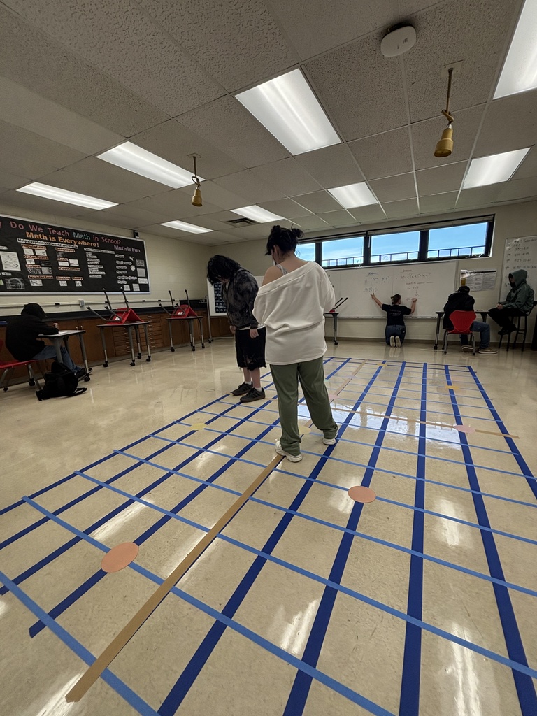 Students using the coordinate plane to figure out a problem.