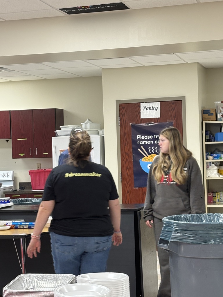 Our Kitchen and Creativity Crew working to put together our school breakfast to build community.