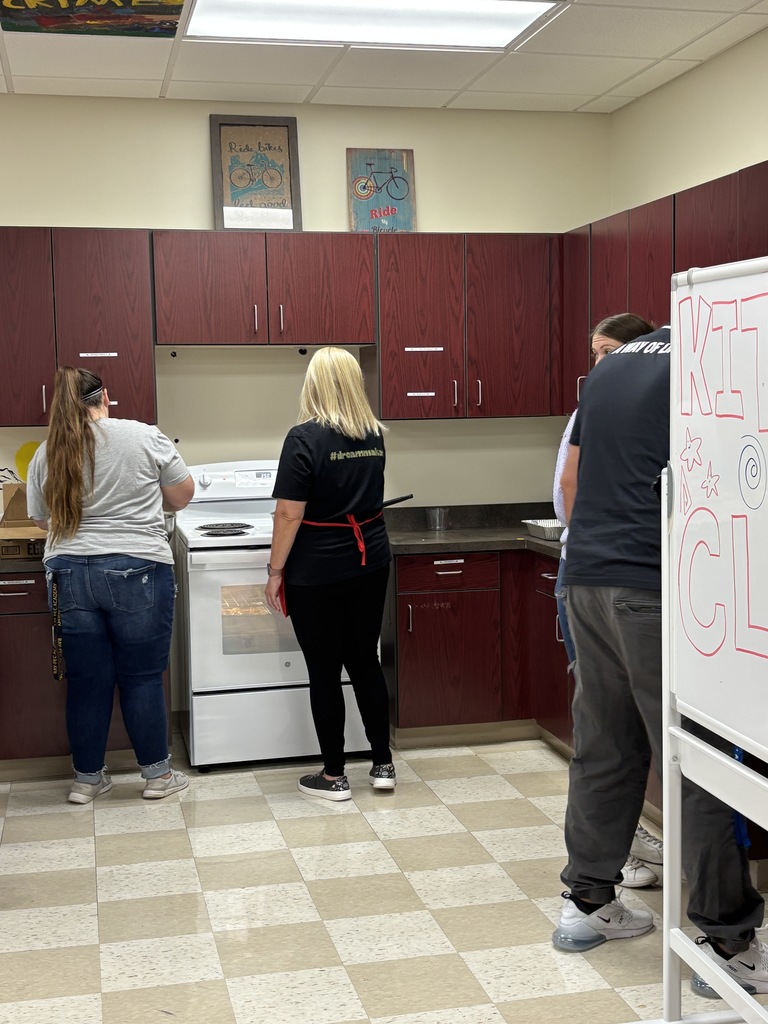 Students and staff working together to make a breakfast for everyone.