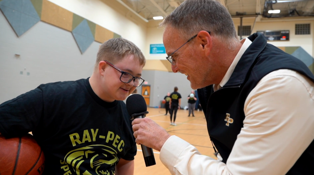 Dr. Mike Slagle speaking to a special olympics athlete