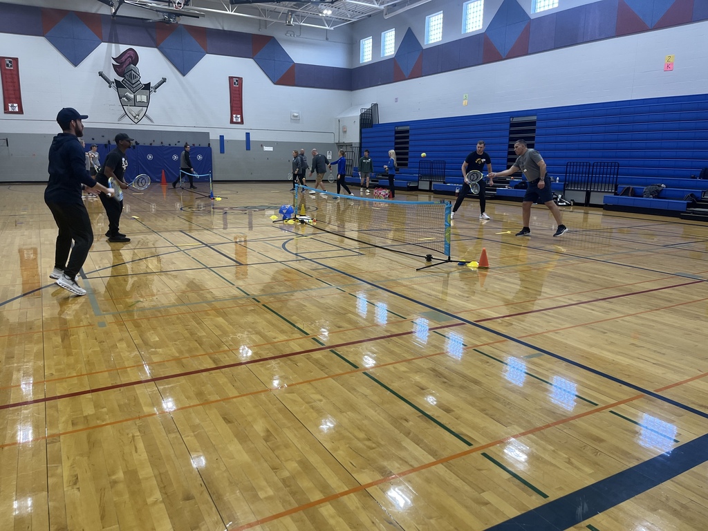 PE Teachers learning tennis instruction from USTA
