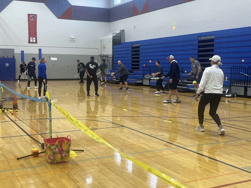 PE Teachers learning tennis instruction from USTA