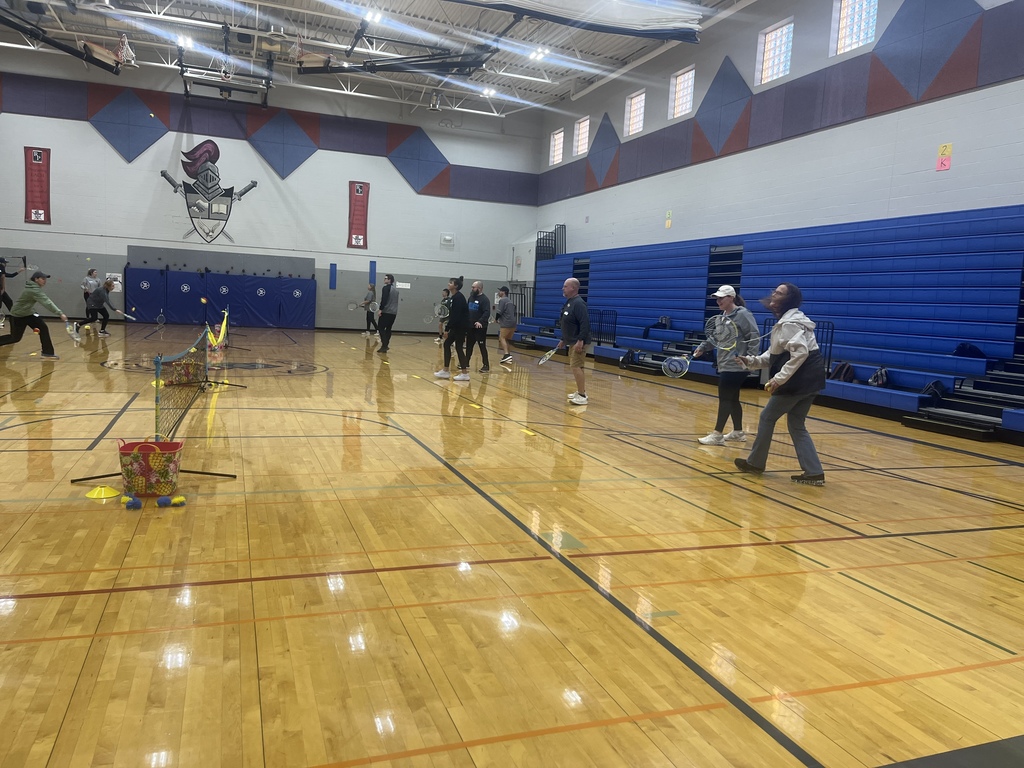 PE Teachers learning tennis instruction from USTA