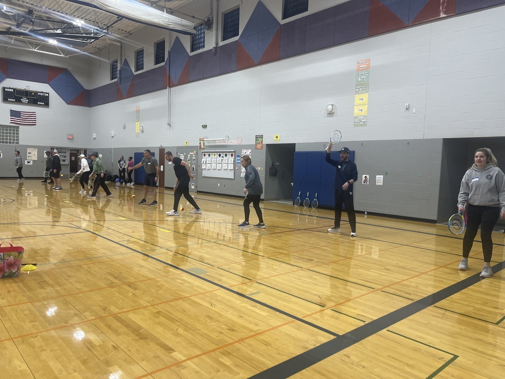PE Teachers learning tennis instruction from USTA