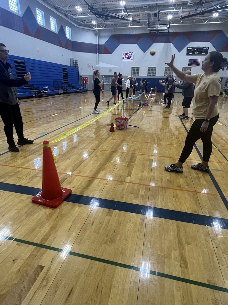 PE Teachers learning tennis instruction from USTA