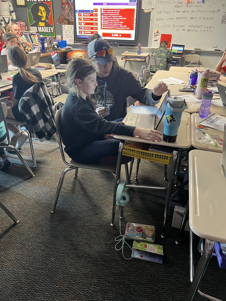 tutoring student helping a younger student