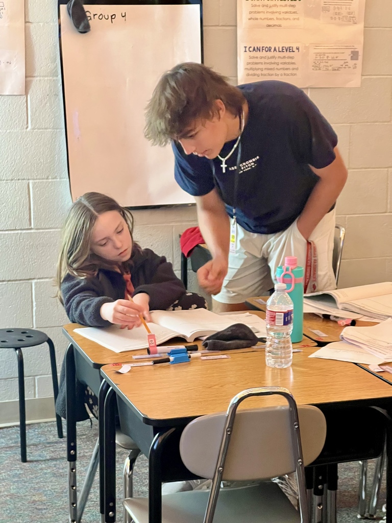 tutoring student helping a younger student
