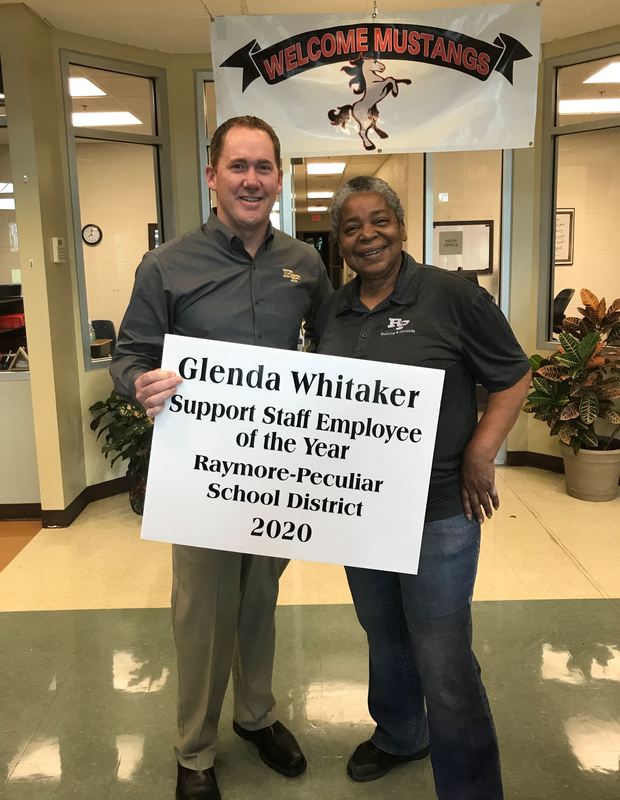 A man and a woman holding a sign that says "Glenda Whitaker Support Staff Employee of the Year 2020"