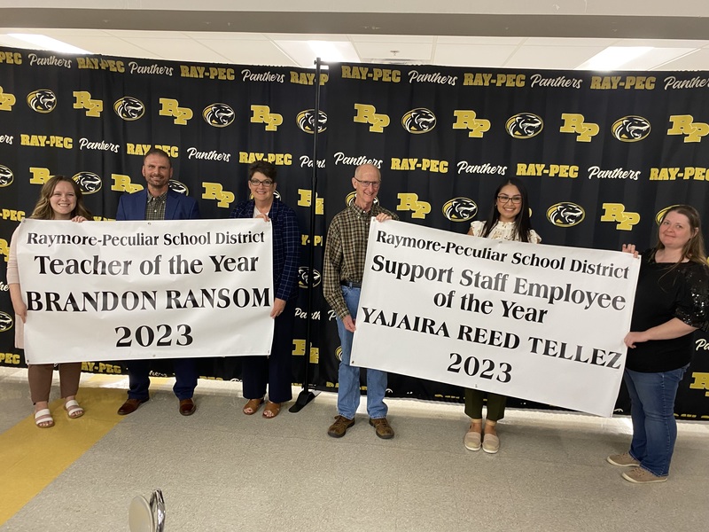 Six people holding up banners that say," 2024 Teacher and Support Staff Employee of the Year"