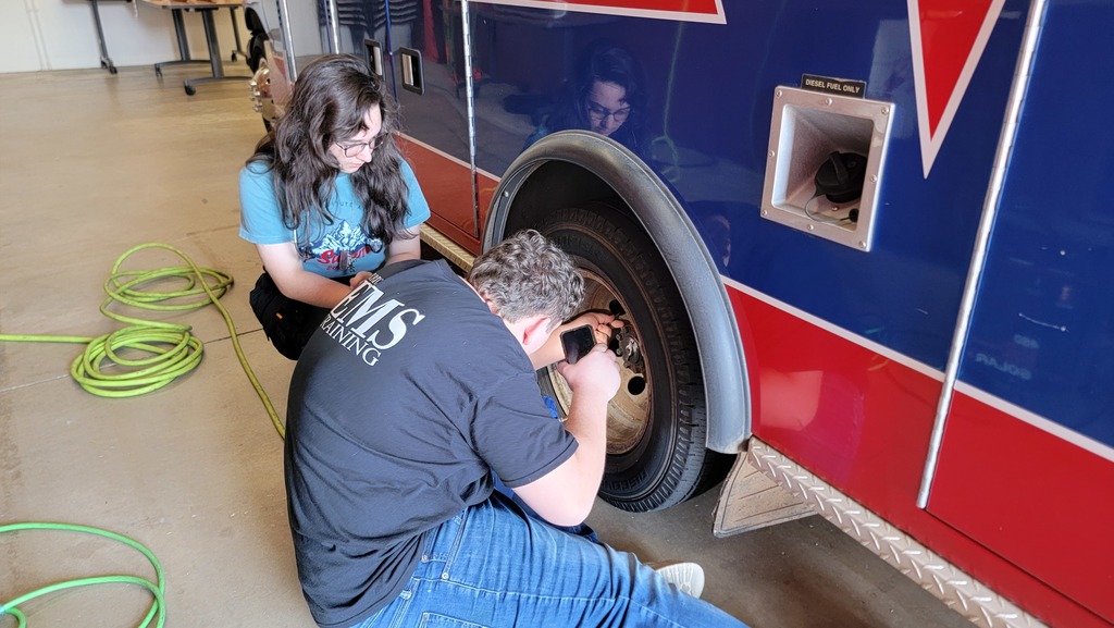 EMS Students completing vehicle  inspection and maintenance