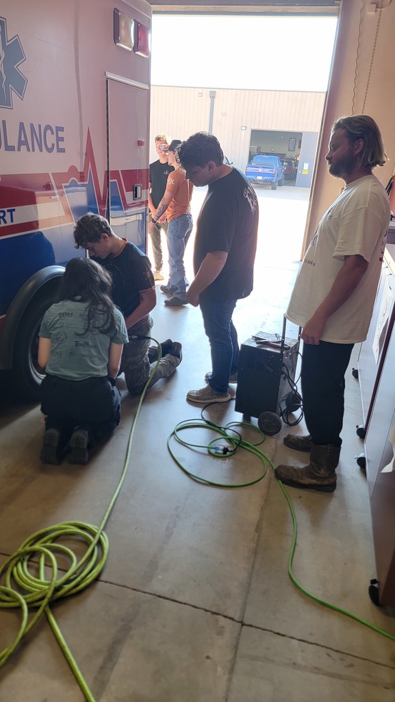 EMS Students completing vehicle  inspection and maintenance