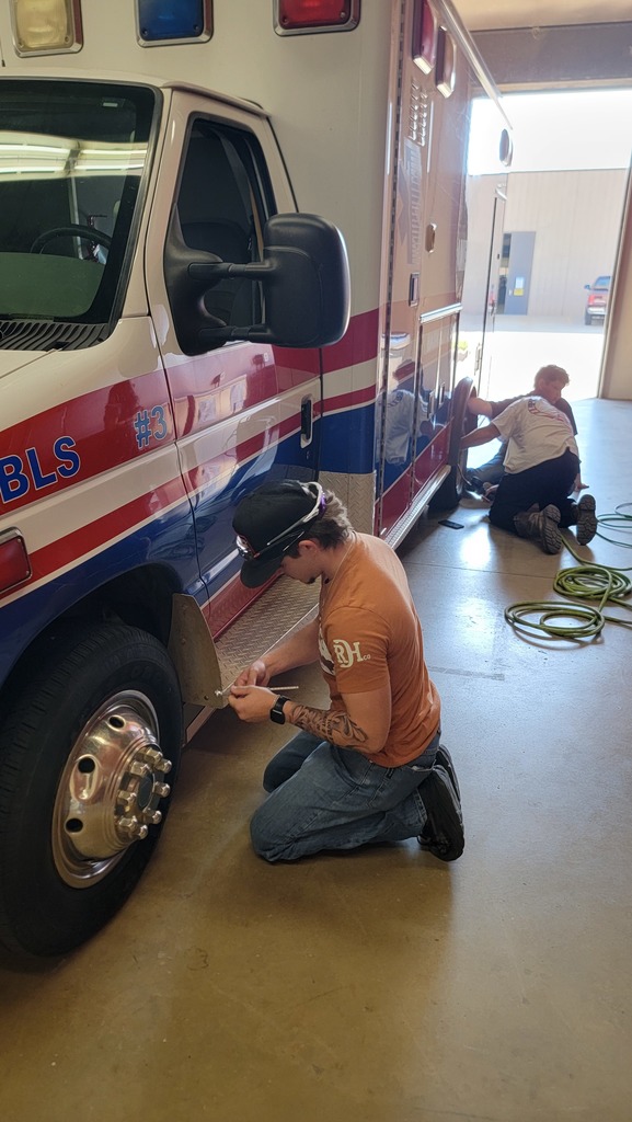 EMS Students completing vehicle  inspection and maintenance
