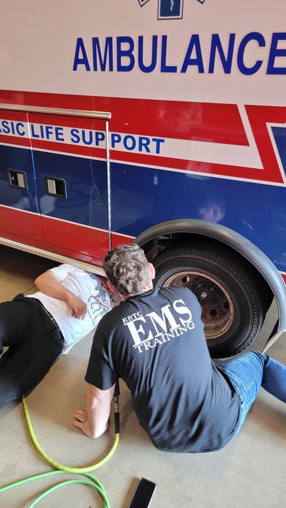 EMS Students completing vehicle  inspection and maintenance