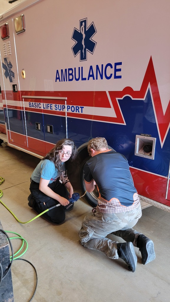 EMS Students completing vehicle  inspection and maintenance