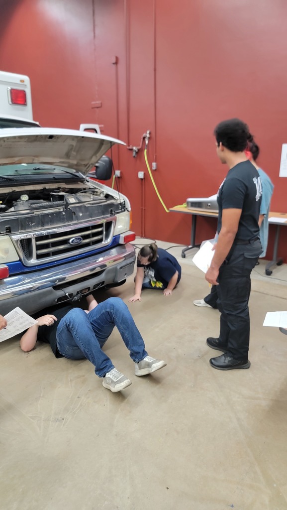 EMS Students completing vehicle  inspection and maintenance