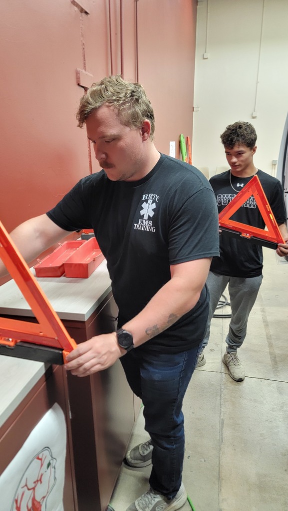 EMS Students completing vehicle  inspection and maintenance