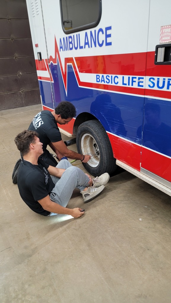 EMS Students completing vehicle  inspection and maintenance