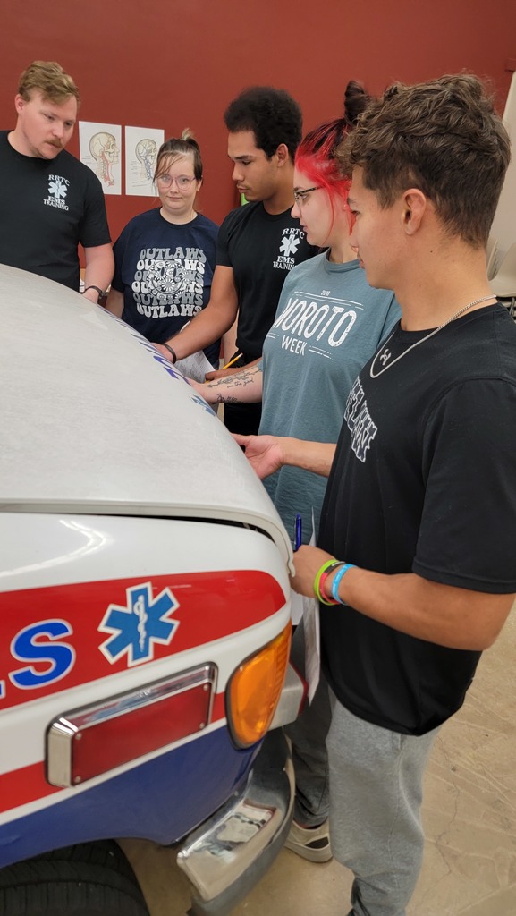 EMS Students completing vehicle  inspection and maintenance