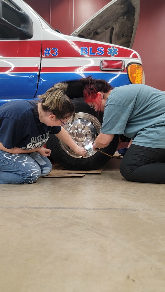 EMS Students completing vehicle  inspection and maintenance