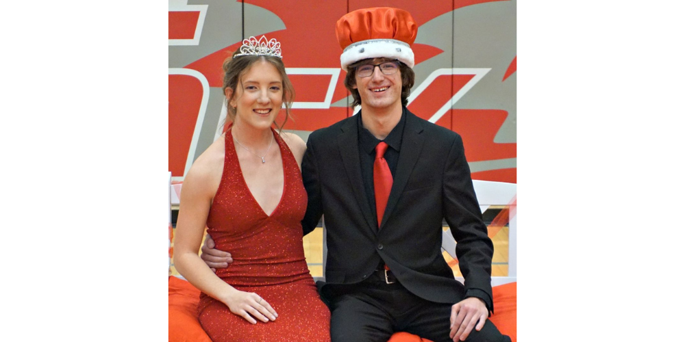 girl and boy in dress clothes wearing crowns