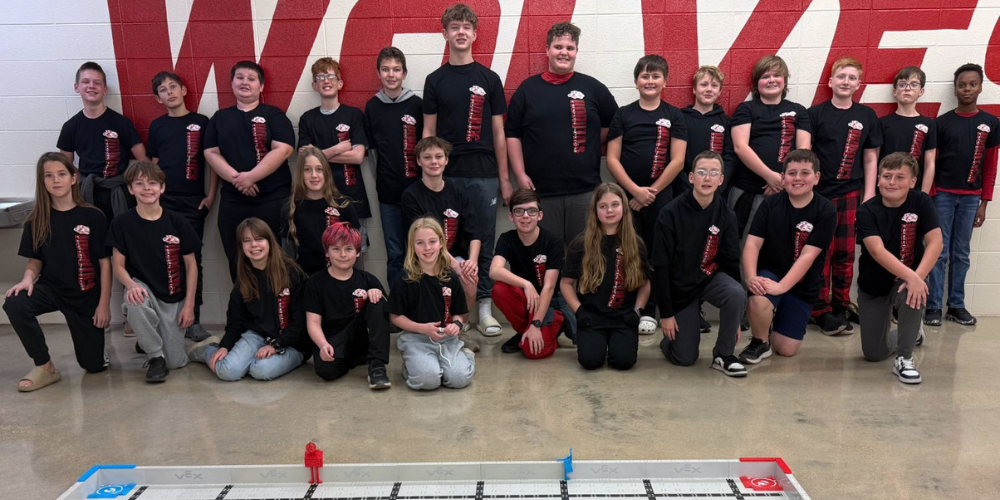 25 students wearing matching black t shirts